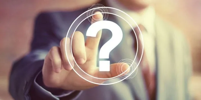 A hand reaching toward a glowing question mark icon